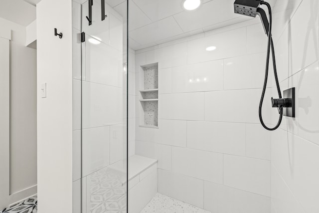 full bathroom with a tile shower