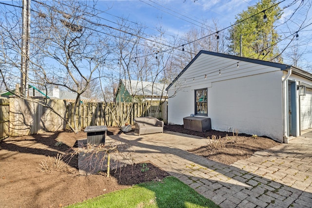 exterior space featuring fence and an attached garage