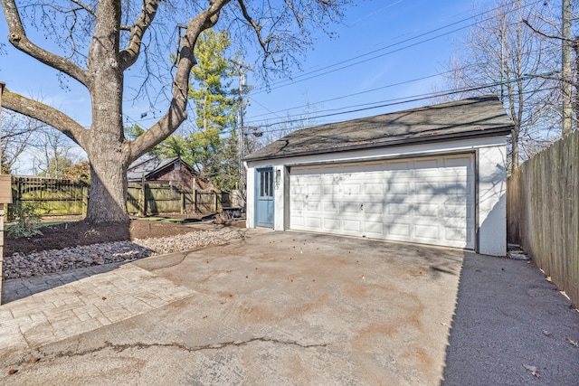 detached garage featuring fence