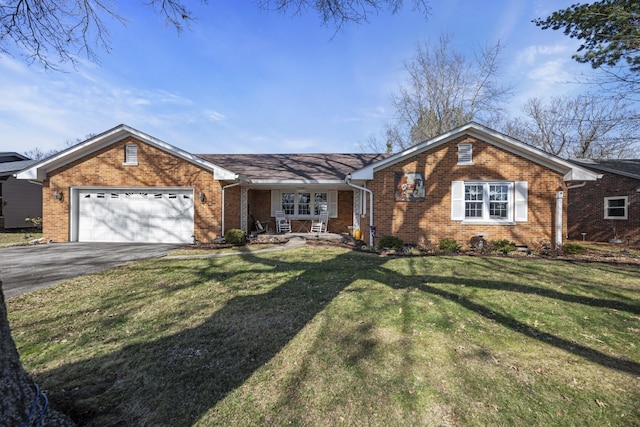 ranch-style house featuring aphalt driveway, a garage, brick siding, and a front lawn