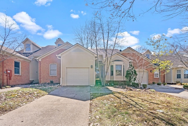 view of front of home with a garage, concrete driveway, and brick siding