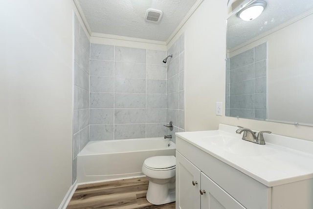 bathroom with shower / bathing tub combination, toilet, vanity, a textured ceiling, and wood finished floors