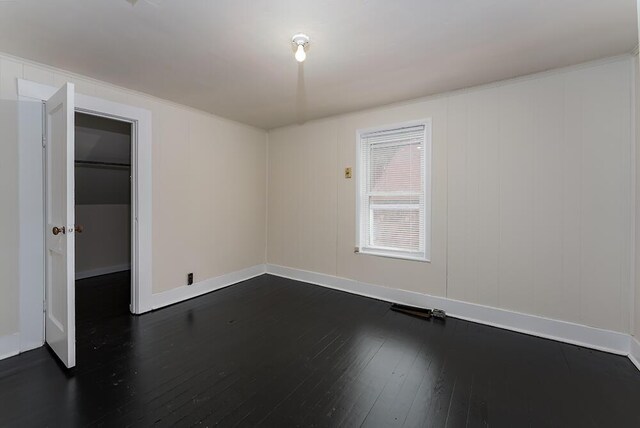 interior space with dark wood finished floors and baseboards