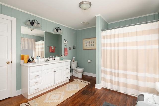 bathroom featuring crown molding, visible vents, toilet, vanity, and wood finished floors