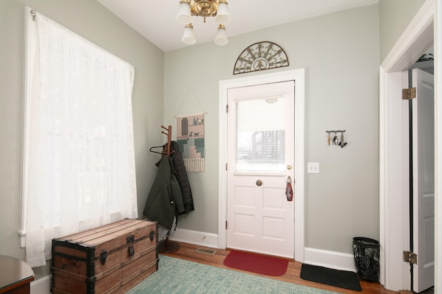 interior space with visible vents, baseboards, and wood finished floors