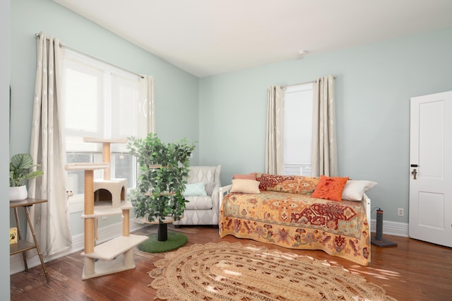 sitting room with baseboards and wood finished floors