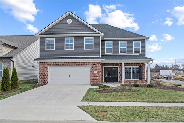 view of front facade with french doors, brick siding, and driveway