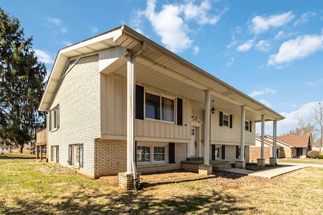 view of front of home with covered porch, board and batten siding, and brick siding