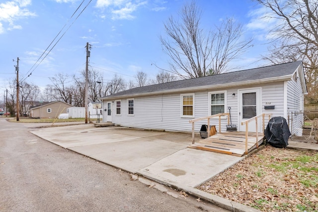 back of property featuring a patio, a wooden deck, and fence