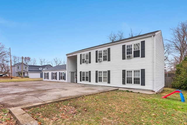 view of front facade featuring a patio, a front yard, and fence