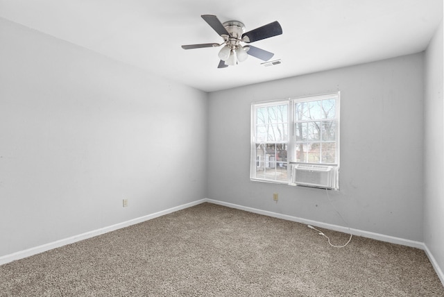 unfurnished room with carpet, visible vents, a ceiling fan, cooling unit, and baseboards