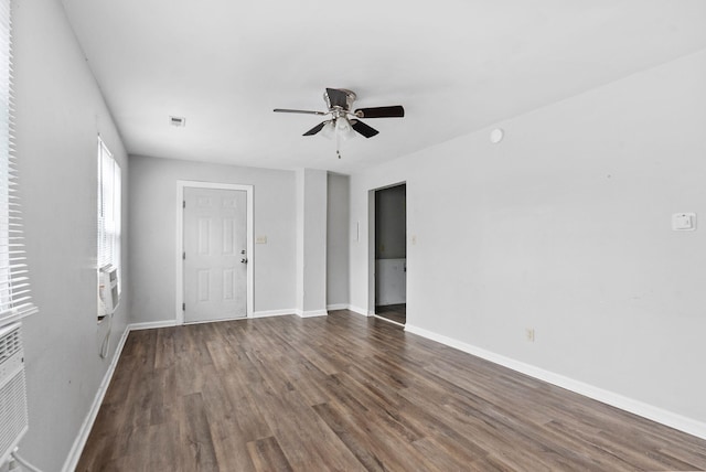 unfurnished room featuring ceiling fan, wood finished floors, visible vents, and baseboards