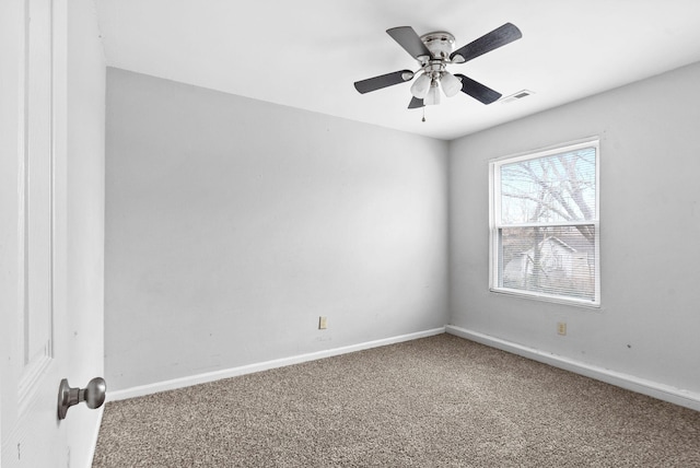 unfurnished room with a ceiling fan, carpet, visible vents, and baseboards