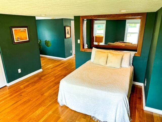 bedroom featuring baseboards and wood finished floors