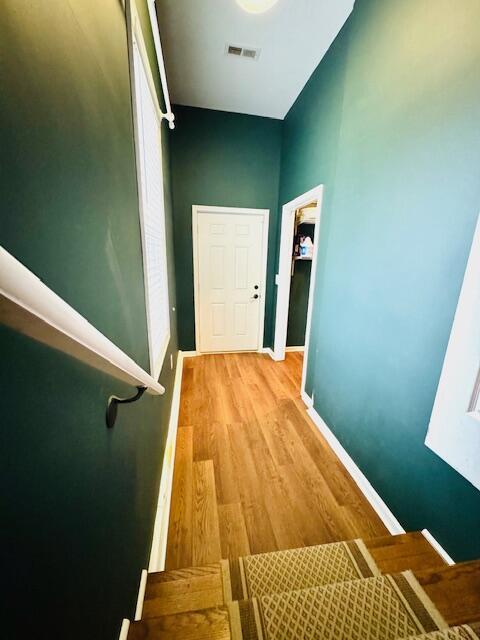 interior space with visible vents, light wood-style flooring, and baseboards