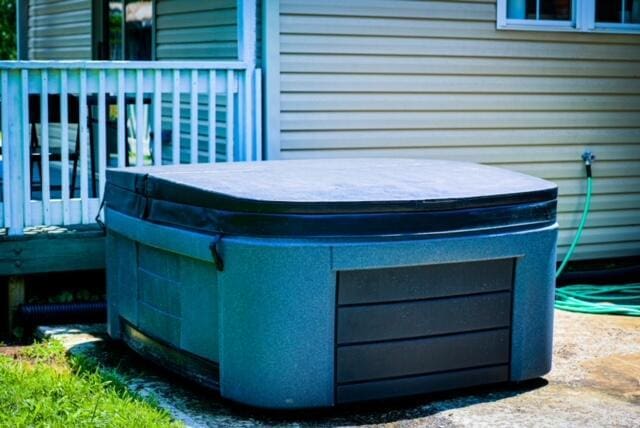 wooden deck featuring a hot tub