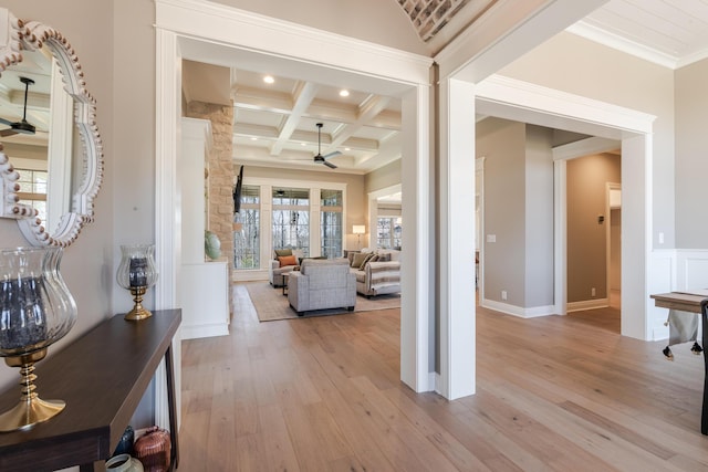 hall featuring recessed lighting, coffered ceiling, ornamental molding, beam ceiling, and light wood finished floors