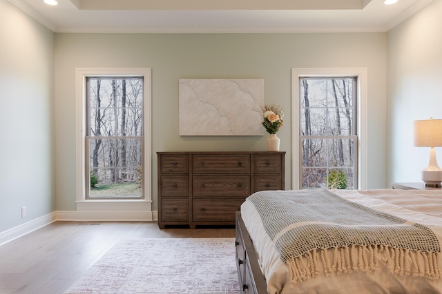 bedroom with ornamental molding, recessed lighting, baseboards, and wood finished floors