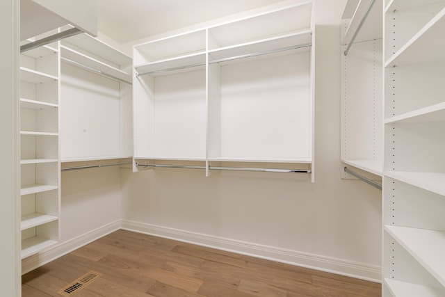 spacious closet with visible vents and wood finished floors