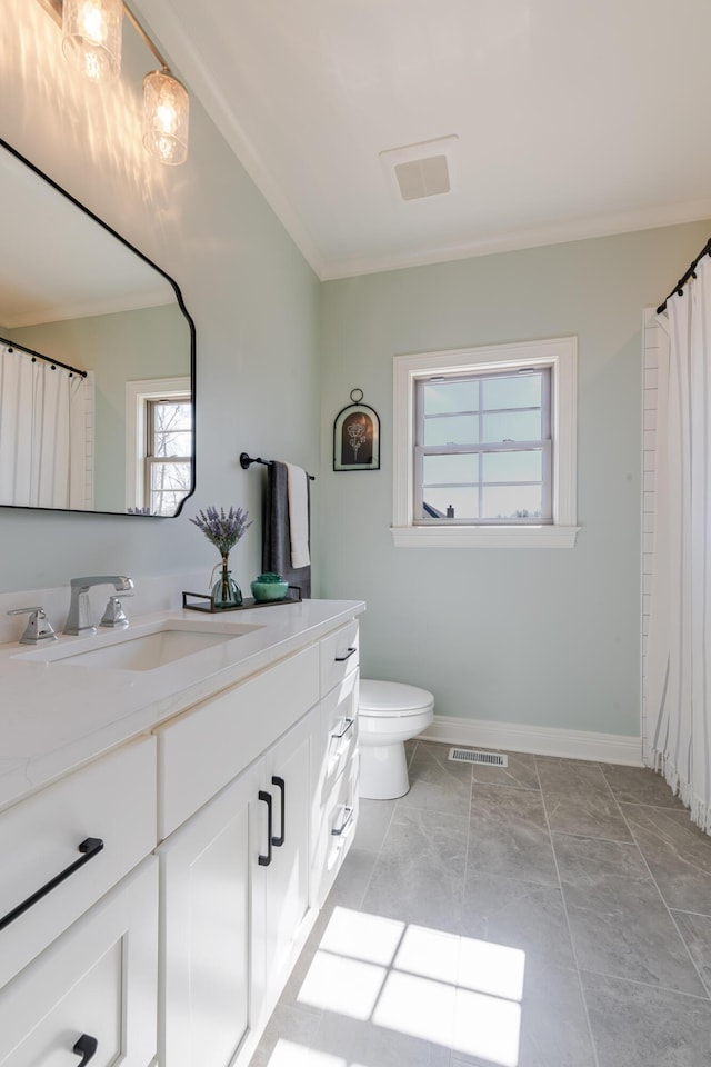 bathroom featuring toilet, visible vents, baseboards, vanity, and crown molding