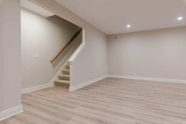 basement with light wood finished floors, baseboards, visible vents, stairs, and recessed lighting