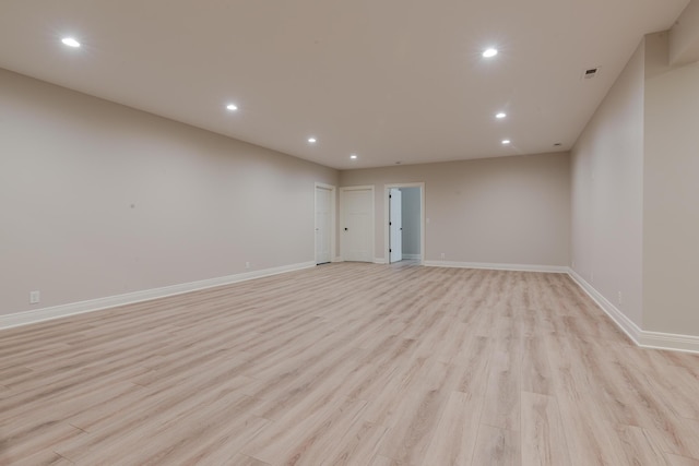 unfurnished room featuring light wood-type flooring, baseboards, and recessed lighting