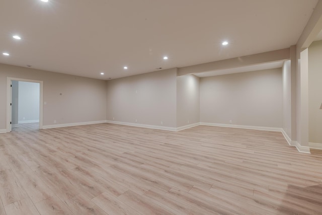 spare room with recessed lighting, light wood-style flooring, and baseboards