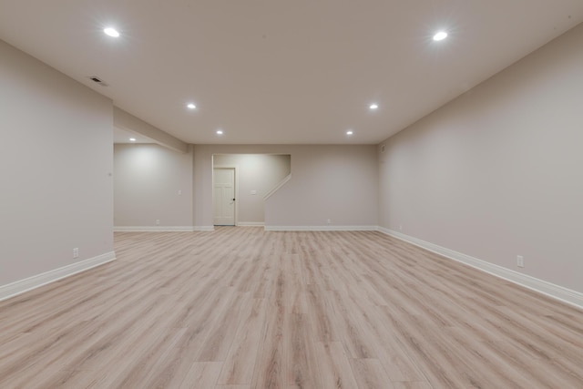 below grade area with light wood-style floors, baseboards, and recessed lighting