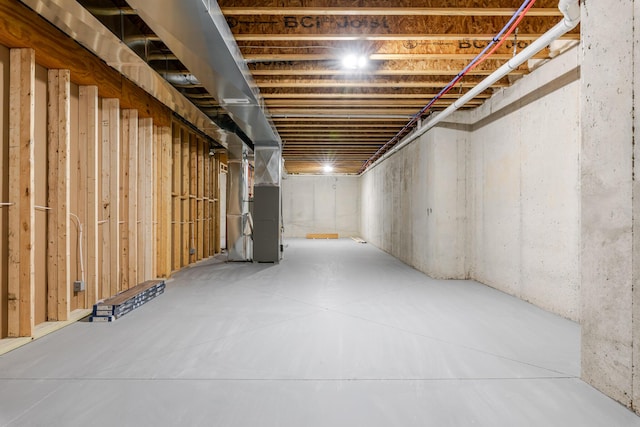 unfinished basement featuring heating unit