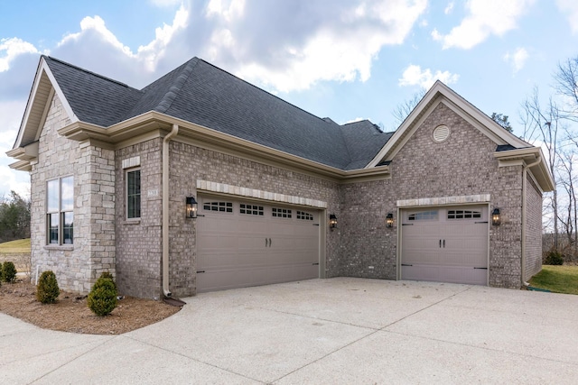 view of side of home with a garage, brick siding, driveway, and roof with shingles