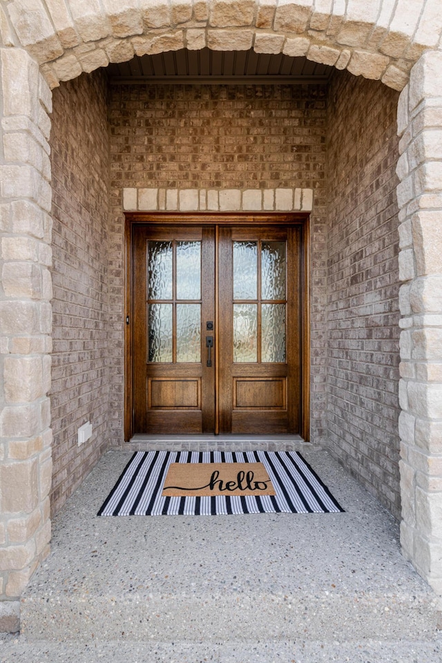 doorway to property with french doors and brick siding