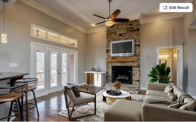 living area featuring a high ceiling, dark wood-style floors, a fireplace, and ornamental molding