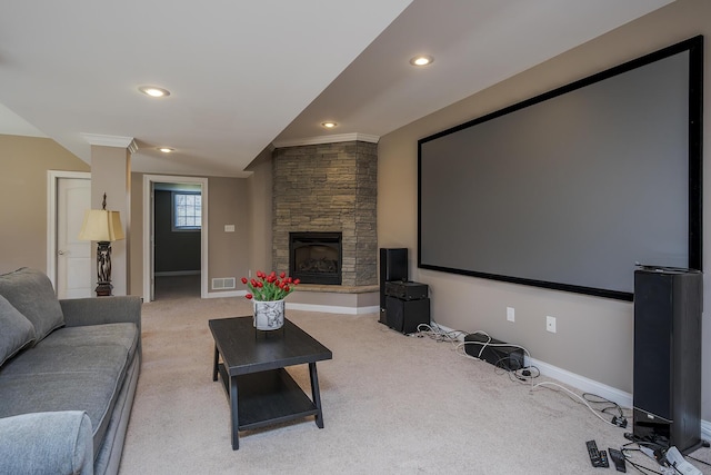 cinema with recessed lighting, visible vents, light carpet, a stone fireplace, and baseboards