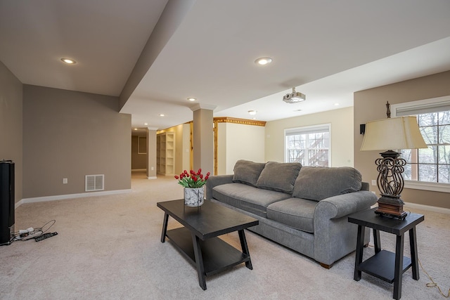 living room with recessed lighting, visible vents, baseboards, and light colored carpet