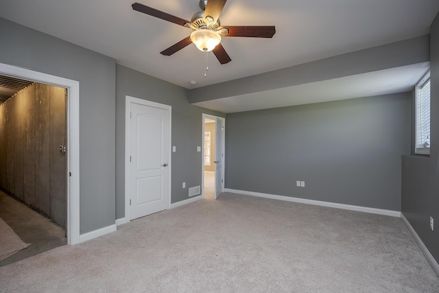 unfurnished bedroom featuring ceiling fan, carpet, visible vents, and baseboards