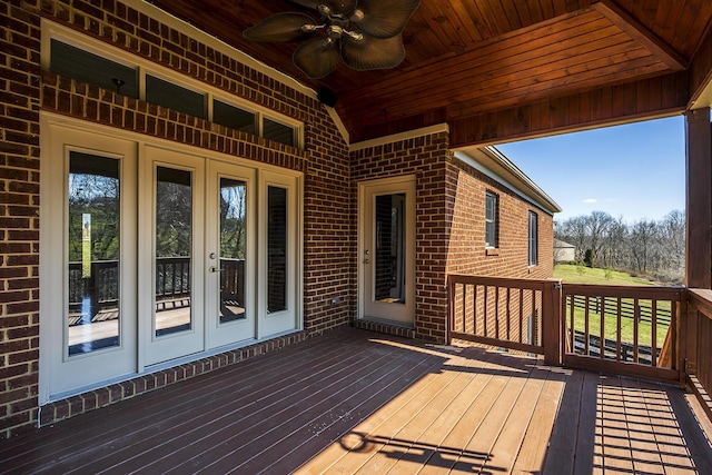 wooden terrace featuring french doors and a ceiling fan