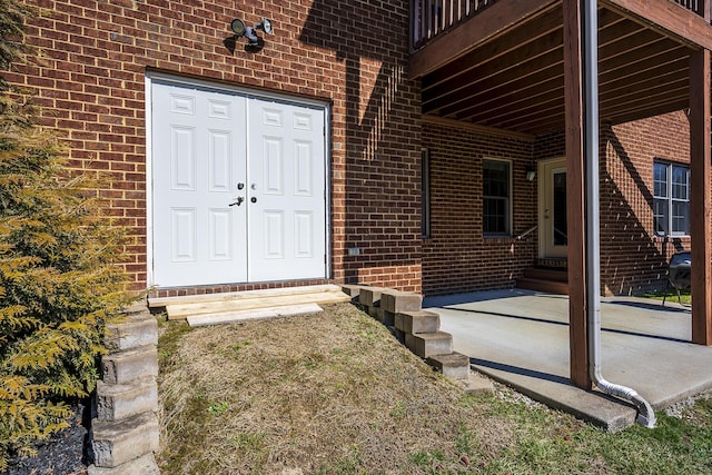 view of exterior entry with brick siding