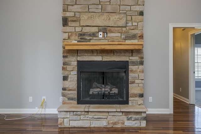 room details with a fireplace, baseboards, and wood finished floors