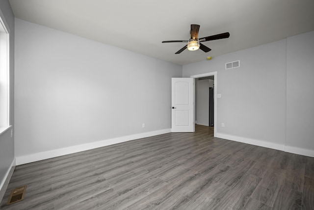 empty room with visible vents, baseboards, ceiling fan, and wood finished floors