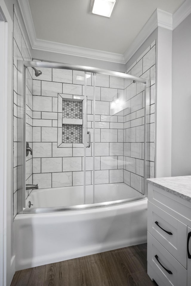 full bath featuring enclosed tub / shower combo, vanity, wood finished floors, and crown molding