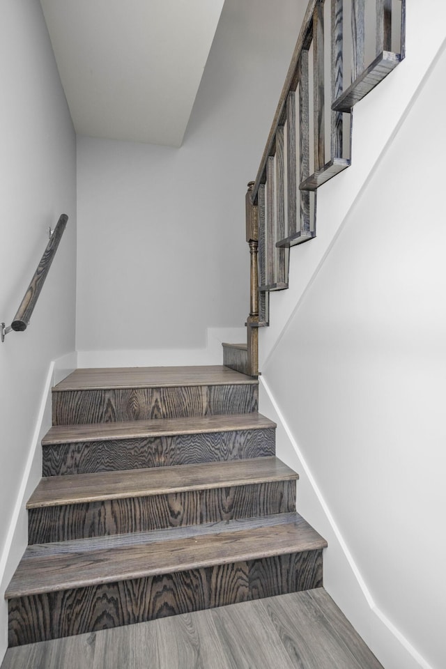 stairs with baseboards and wood finished floors