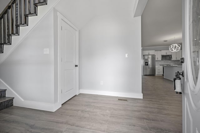 213 Richmond St, Lancaster, KY 40444 - entryway featuring wood finished floors, baseboards, stairs, and visible vents