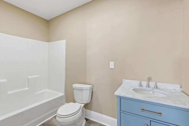 full bath featuring toilet, baseboards, wood finished floors, and vanity