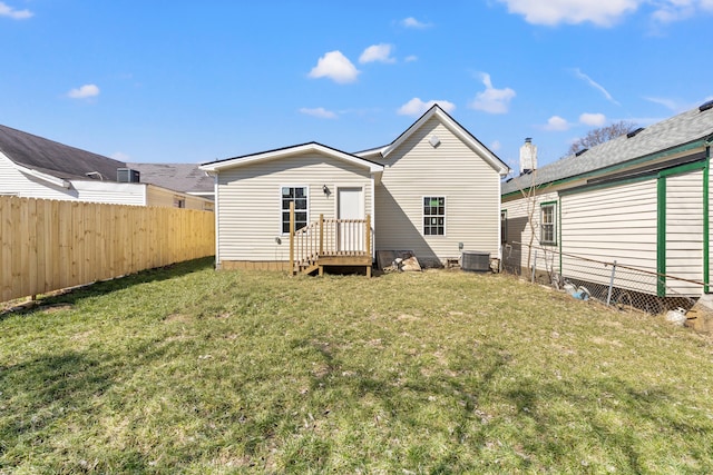 back of house with a yard, cooling unit, and fence