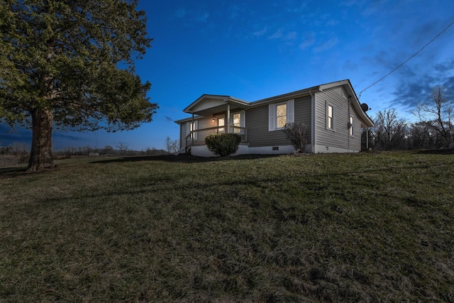 view of side of property featuring crawl space and a lawn