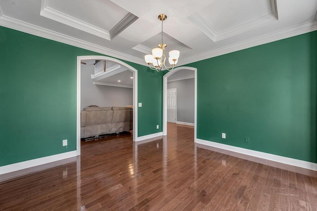 unfurnished dining area with arched walkways, an inviting chandelier, wood finished floors, coffered ceiling, and baseboards