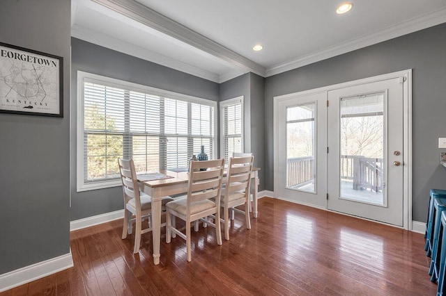 dining area with ornamental molding, dark wood-style flooring, and baseboards