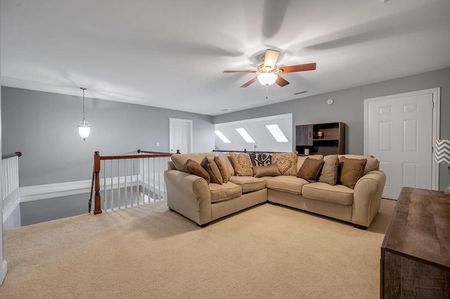 living area featuring carpet and ceiling fan