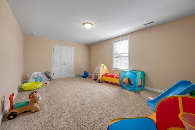 rec room featuring baseboards, visible vents, and carpet flooring