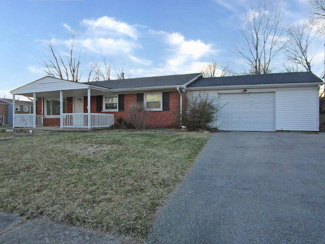 ranch-style house with a porch, aphalt driveway, a garage, brick siding, and a front yard